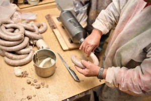 Man stuffing sausages